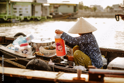 A Vietnamese woman selling drinks on the Cai Rang floating market in Vietnam