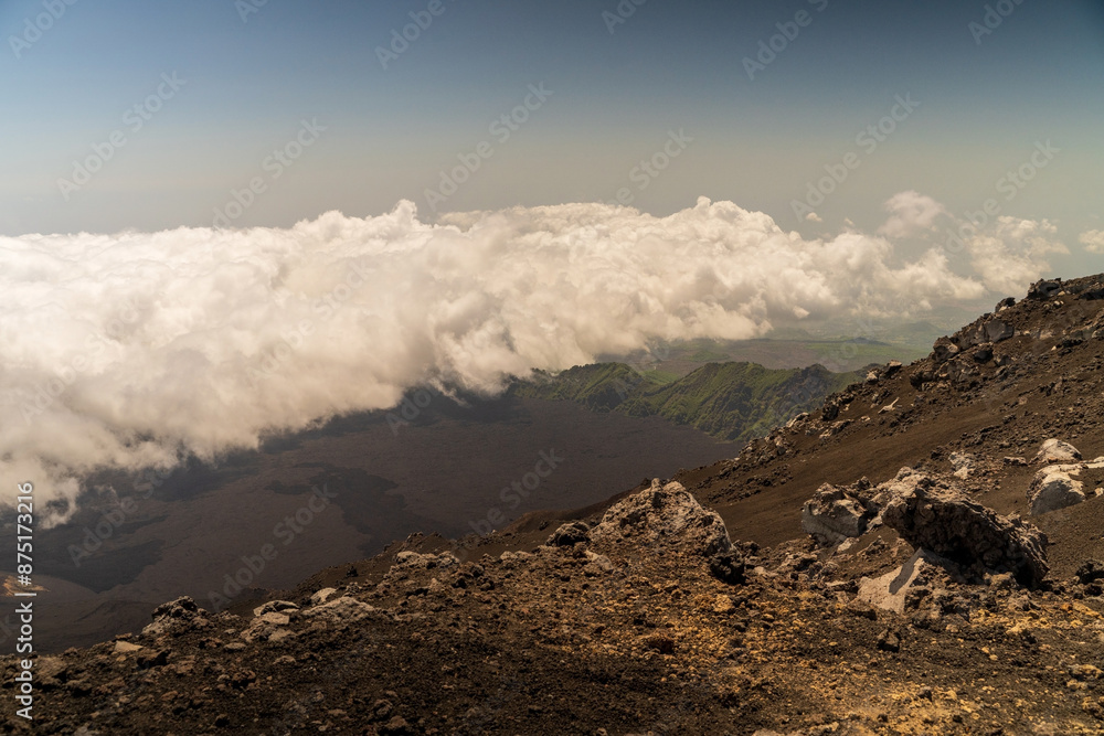 Clouds naturally formed around mount etna volcano on the top altitude