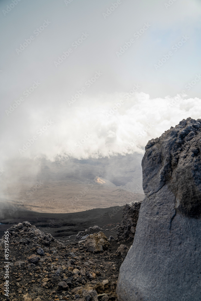Clouds naturally formed around mount etna volcano on the top altitude with rocky formation