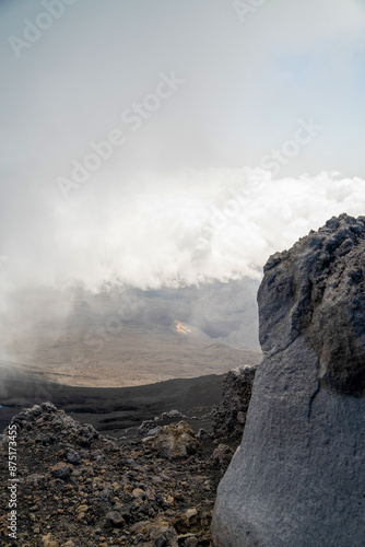 Obraz na płótnie Clouds naturally formed around mount etna volcano on the top altitude with rocky formation w salonie