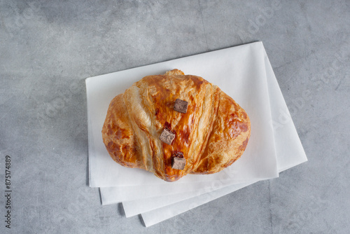 A top down view of a chocolate croissant. photo