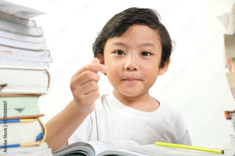 A determined child, sitting among stacks of books, points forward with focus and intent. Perfect for themes of education, determination, study, childhood learning, and academic achievement. A determined child, sitting among stacks of books, points forward with focus and intent. Perfect for themes of education, determination, study, childhood learning, and academic achievement.