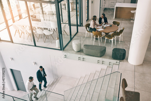 High angle, office and business people in lobby for corporate work, accounting agency and reception area. Male partners, women and success in company on steps, start and morning in finance department photo