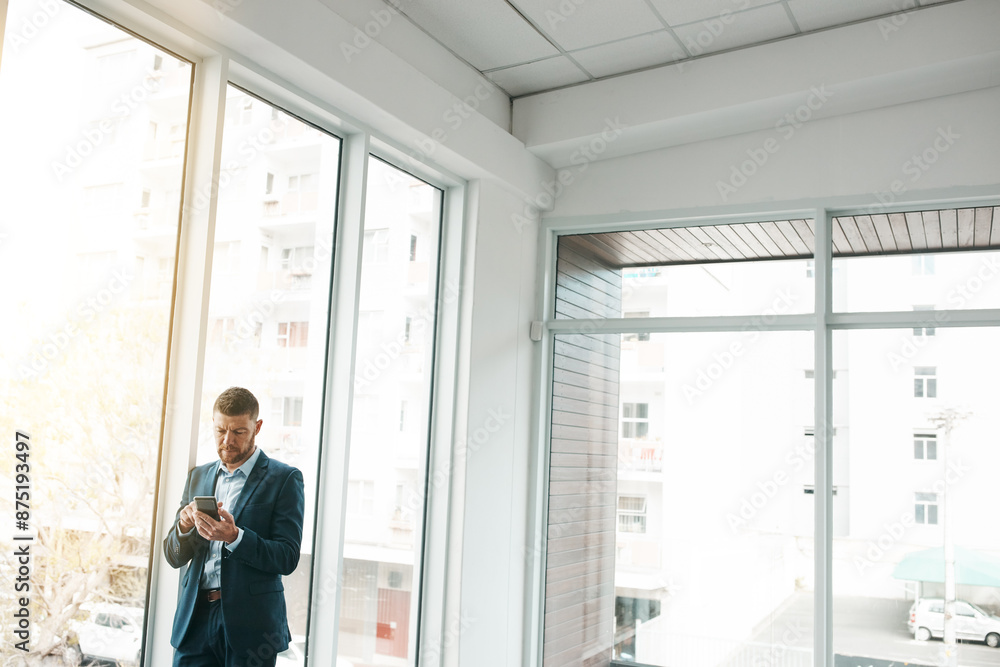 Business, empty office and man with smartphone for email or communication and networking. Entrepreneur, property and serious for online or digital application with funding for startup company Business, empty office and man with smartphone for email or communication and networking. Entrepreneur, property and serious for online or digital application with funding for startup company