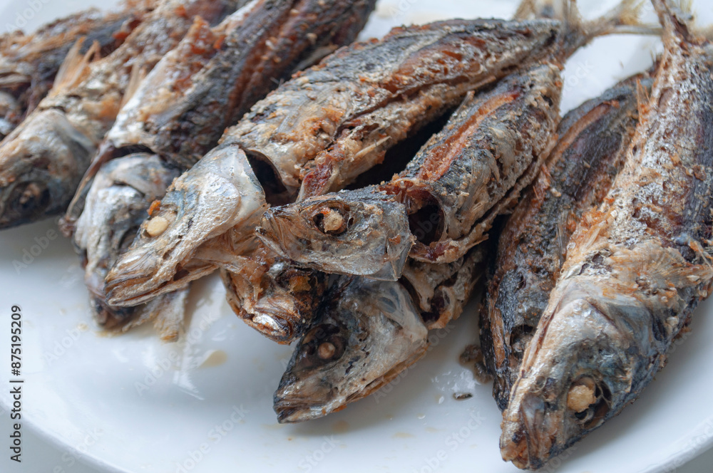 Deep fried sardines fish on white place. Asian food concept.