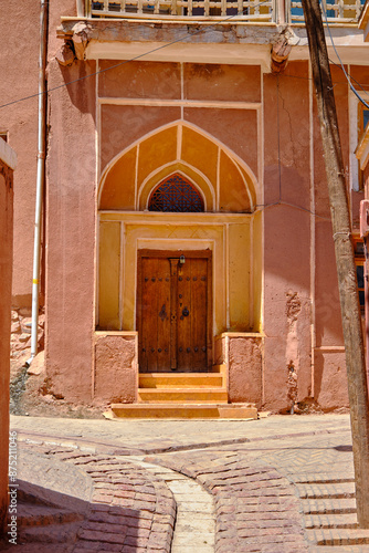 Ancient wooden door in Abyaneh, adobe house door in Iran. photo