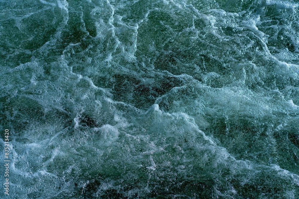Fototapeta premium Foaming water after a waterfall.