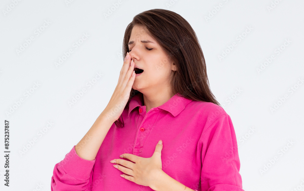 Tired woman yawning covering open mouth with hand need rest. Young female worker being sleepy head can't wake up having insomnia. Chain reaction Tired woman yawning covering open mouth with hand need rest. Young female worker being sleepy head can't wake up having insomnia. Chain reaction