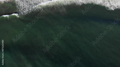 Wallpaper Mural Aerial slow-motion shot of the Ocean waves on Nazare beach with beachgoers on the sand in Portugal Torontodigital.ca