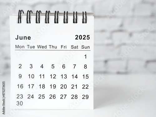 June 2025 white monthly desk calendar on a table