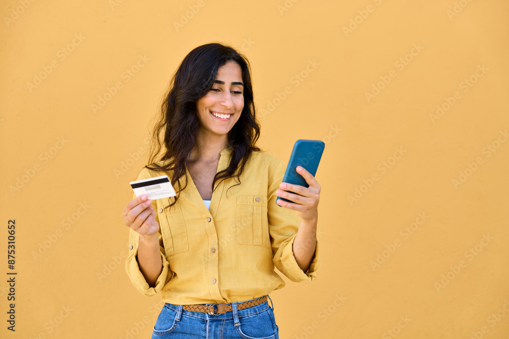 Young middle eastern businesswoman holding mobile cell phone, debit credit bank card isolated. Indian, Arabian female shopper, business woman using smartphone for shopping, buying, e commerce online Young middle eastern businesswoman holding mobile cell phone, debit credit bank card isolated. Indian, Arabian female shopper, business woman using smartphone for shopping, buying, e commerce online
