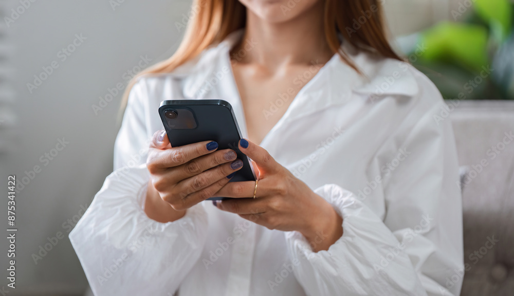 Woman Relaxing in the Morning with Smartphone, Enjoying Leisure Time in Cozy Home Environment Woman Relaxing in the Morning with Smartphone, Enjoying Leisure Time in Cozy Home Environment