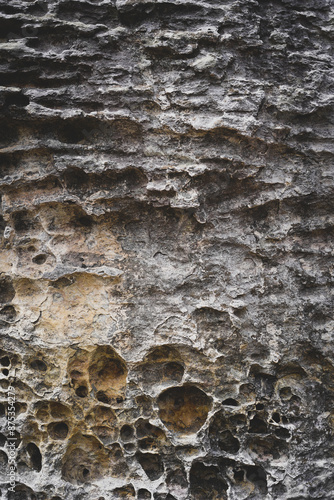 Empty dark grey rough stone wall on cave for abstract background and texture. beautiful patterns, space for work, banner, wallpaper close up.