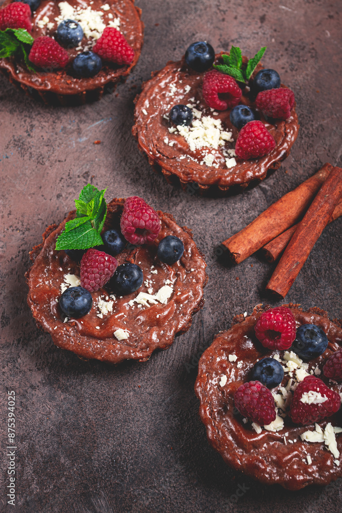 Fototapeta premium chocolate tartlets, stuffed with cottage cheese and berries, breakfast, homemade, no people,