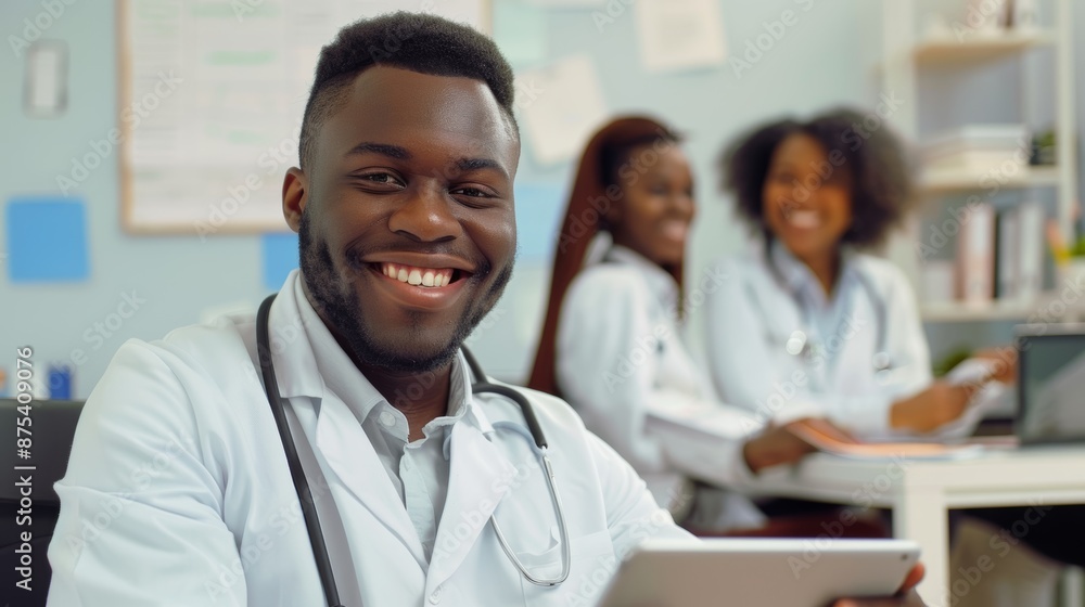 After a conference or presentation, a doctor on a tablet in a hospital boardroom or office. Medical professional smiling at a table online. A coffee break for doctors at work. After a conference or presentation, a doctor on a tablet in a hospital boardroom or office. Medical professional smiling at a table online. A coffee break for doctors at work.