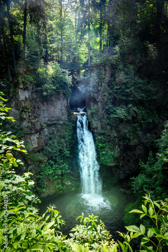 Wilczki waterfall surrounded with green forest in Miedzygorze, Poland. photo