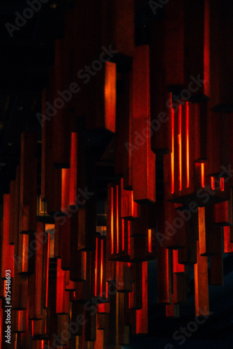Vertical photo of red lights in a restaurant, red and black vertical geometric lines, shapes, orange, 