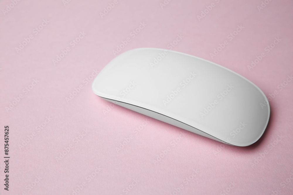 One wireless mouse on pink background. Space for text One wireless mouse on pink background. Space for text