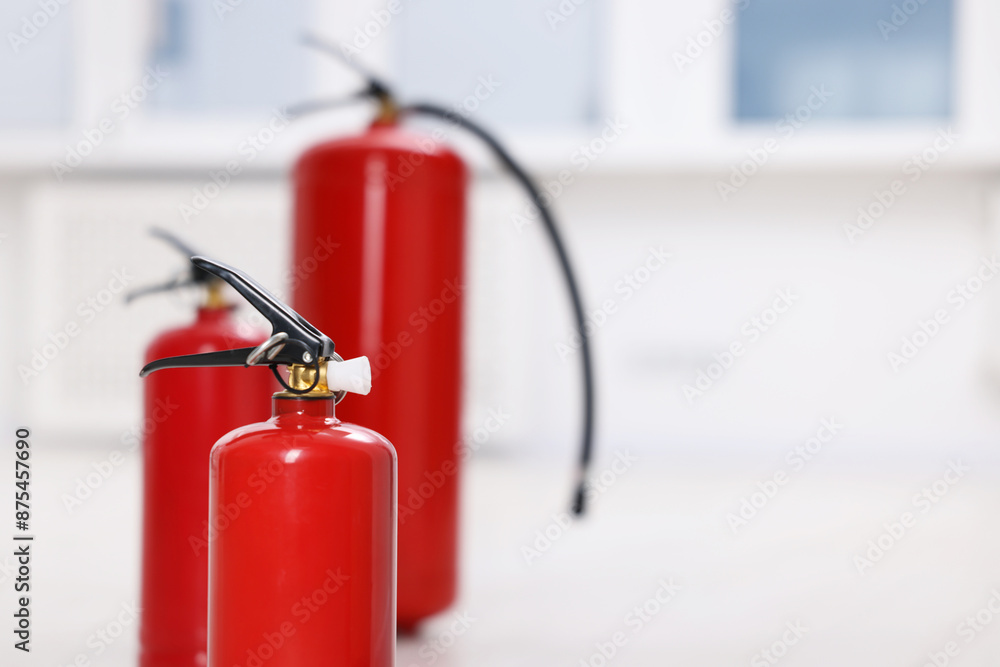 Obraz premium Fire extinguisher indoors, closeup. Space for text