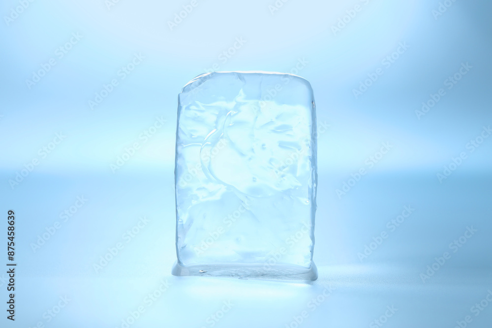 Cube of clear ice on light blue background Cube of clear ice on light blue background