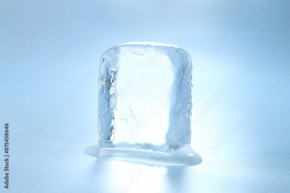 Cube of clear ice on light blue background Cube of clear ice on light blue background