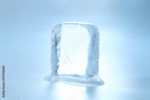 Cube of clear ice on light blue background