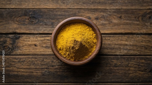 top view of mustard powder in a small wooden plate iso background