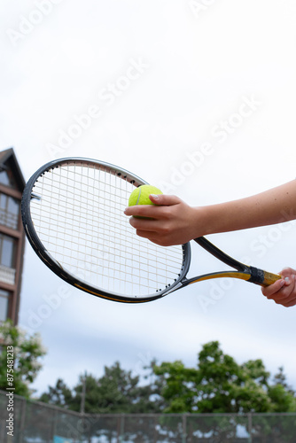 Young girl tennis player on a clay tennis court .