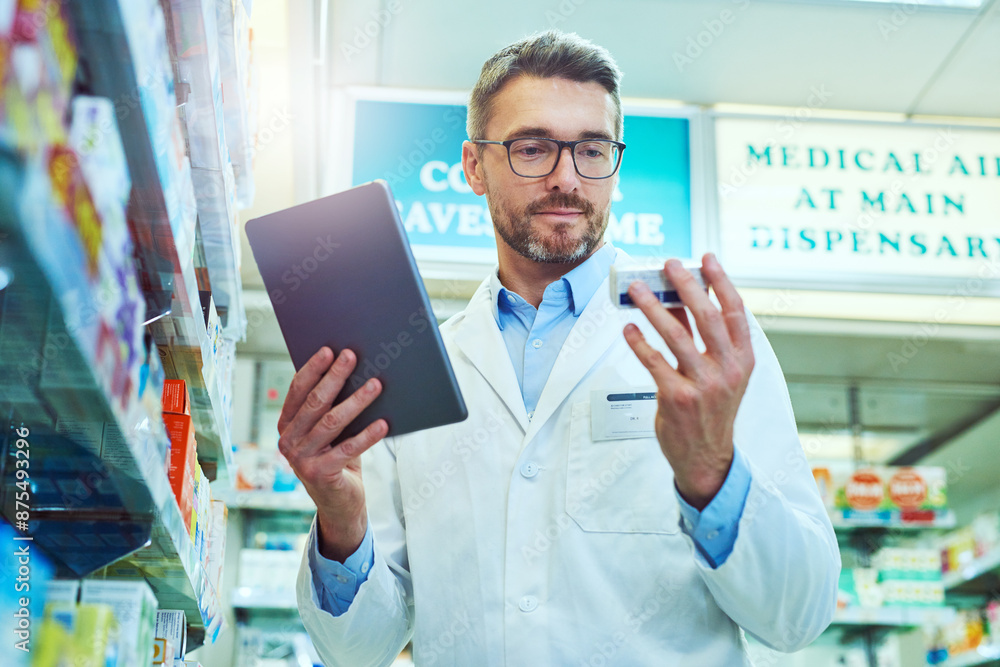 Man, pharmacist and checking box with tablet for prescription, side effects or symptoms at pharmacy. Mature male person or medical employee with technology for inventory, stock or pharmaceuticals Man, pharmacist and checking box with tablet for prescription, side effects or symptoms at pharmacy. Mature male person or medical employee with technology for inventory, stock or pharmaceuticals