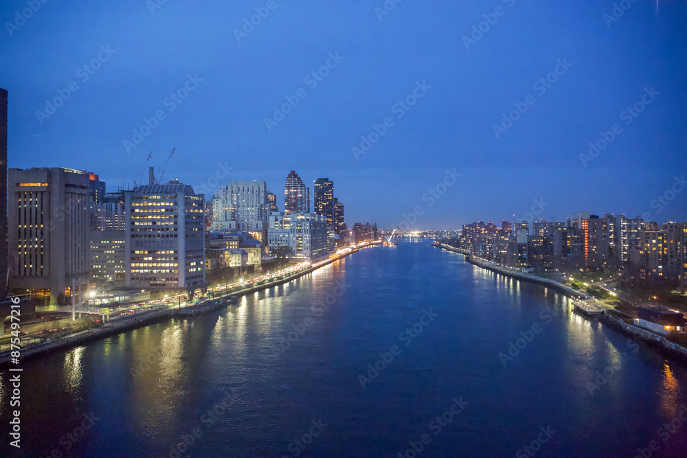 Naklejka premium New York City, New York, USA - Drone view of the East River, Roosevelt Island, the FDR drive with the Triboro Bridge in the distance