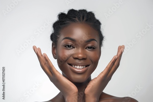 Beautiful Afro american woman with flawless skin. Skincare concept. Beautiful young black girl practicing skincare. smooth face touches her healthy facial skin. Copy space for text.