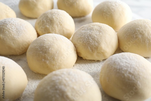 Many raw dough balls on board, closeup