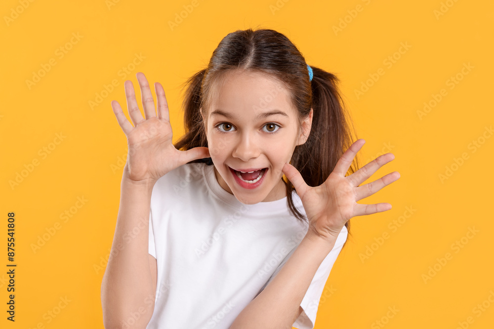 Portrait of emotional girl on orange background Portrait of emotional girl on orange background