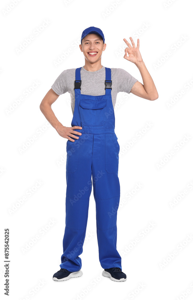 Smiling auto mechanic showing ok gesture on white background Smiling auto mechanic showing ok gesture on white background