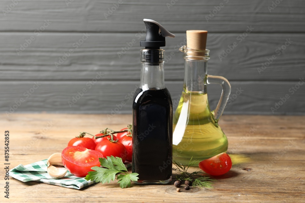 Bottle of balsamic vinegar, oil and other products on wooden table Bottle of balsamic vinegar, oil and other products on wooden table