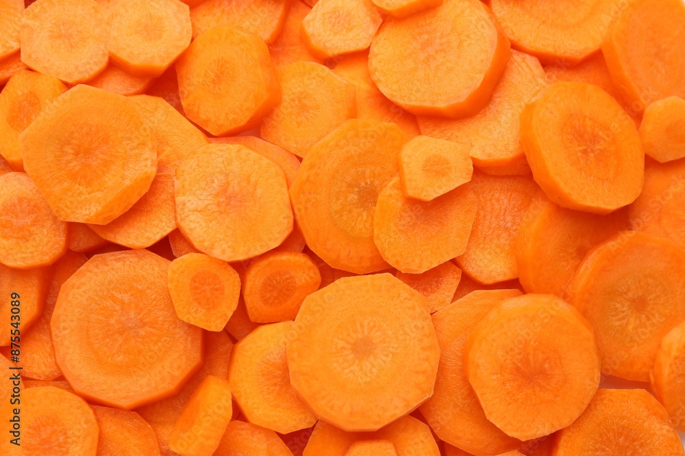 Slices of fresh ripe carrot as background, top view Slices of fresh ripe carrot as background, top view