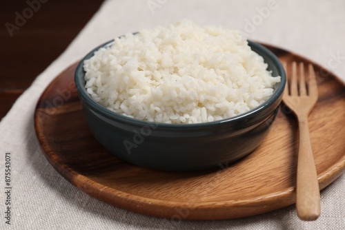 Delicious boiled rice in bowl on table