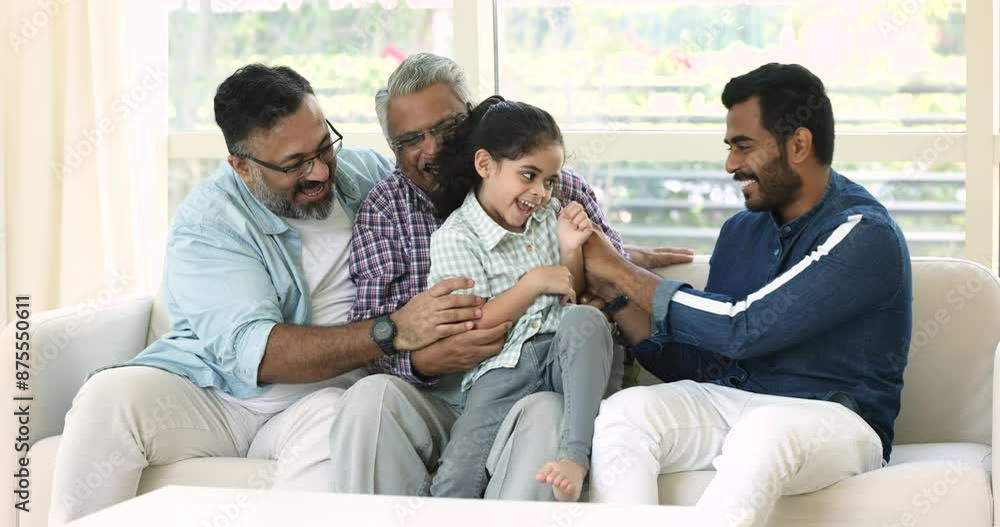 Cheerful young daddy, loving grandfather and great grandpa tickling happy little kid girl, playing active games at home, sitting on couch, laughing, laving fun, relaxing together Cheerful young daddy, loving grandfather and great grandpa tickling happy little kid girl, playing active games at home, sitting on couch, laughing, laving fun, relaxing together