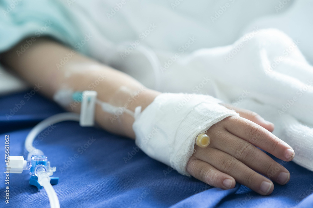 Asian todler in hospital with intravenous saline. Sick children, infected with the virus, are lying and being treated in beds in hospitals. Asian todler in hospital with intravenous saline. Sick children, infected with the virus, are lying and being treated in beds in hospitals.