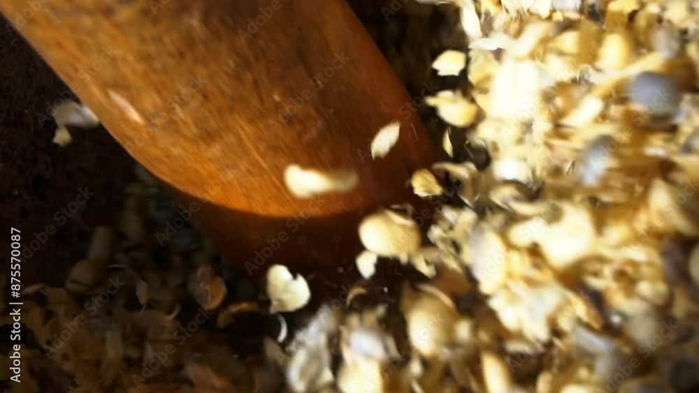 Close-Up Shot Of Pestle Crushing Grains In Mortar On Sunny Day - Dar es Salaam, Tanzania Close-Up Shot Of Pestle Crushing Grains In Mortar On Sunny Day - Dar es Salaam, Tanzania