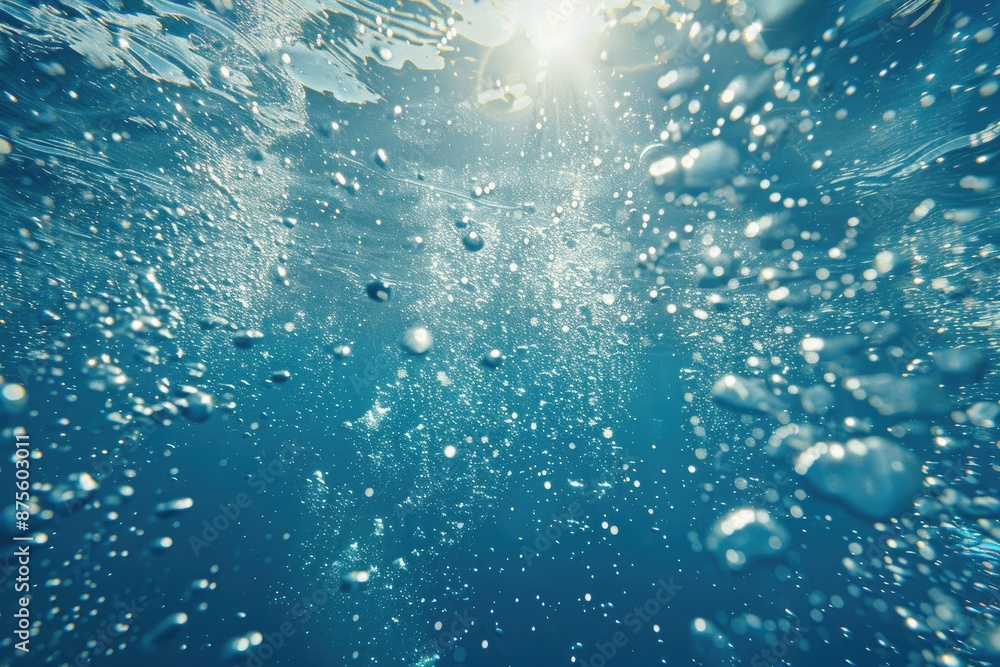 The image is of a clear blue ocean with many small bubbles floating in the water. The bubbles are scattered throughout the water, creating a sense of movement and life The image is of a clear blue ocean with many small bubbles floating in the water. The bubbles are scattered throughout the water, creating a sense of movement and life