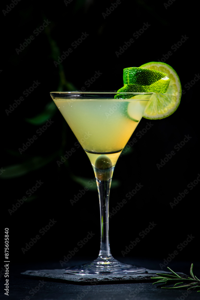 Classic alcoholic cocktail with vodka, syrup, lime, juice and ice in martini glass, dark background Classic alcoholic cocktail with vodka, syrup, lime, juice and ice in martini glass, dark background