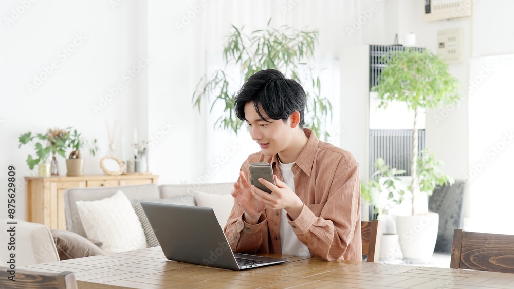 パソコンとスマートフォンを使う男性 パソコンとスマートフォンを使う男性