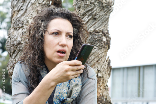 Professional Businesswoman Close-Up with cell phone. Office woman. Exterior. Latina