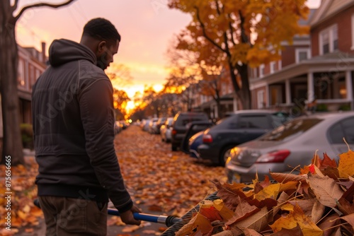 Autumn cleanup: Man using fan rake to gather fallen leaves