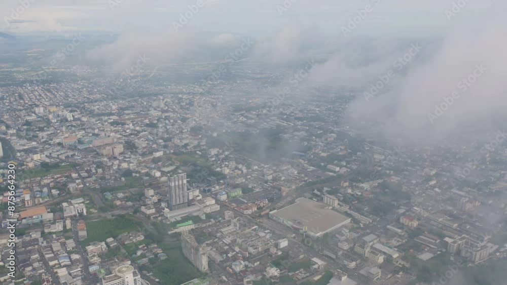 Aerial view of residential neighborhood roofs with fog mist in rainy season. Urban housing development from above. Top view. Real estate in Phuket, southern province city, Thailand. Aerial view of residential neighborhood roofs with fog mist in rainy season. Urban housing development from above. Top view. Real estate in Phuket, southern province city, Thailand.