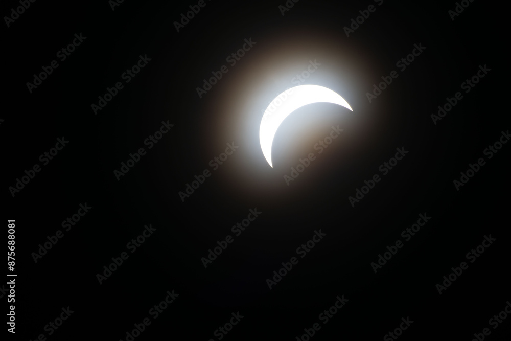 Total eclipse waxing as moon begins to cover the sun Total eclipse waxing as moon begins to cover the sun