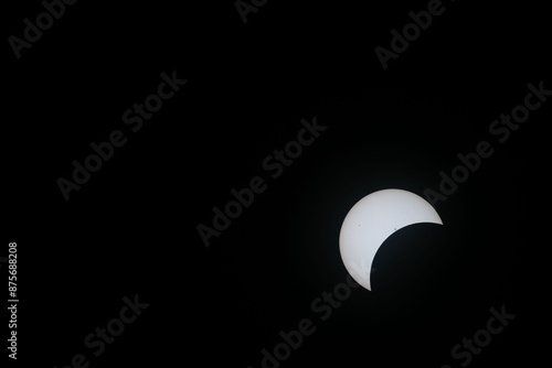 Total eclipse waxing as moon begins to cover the sun photo