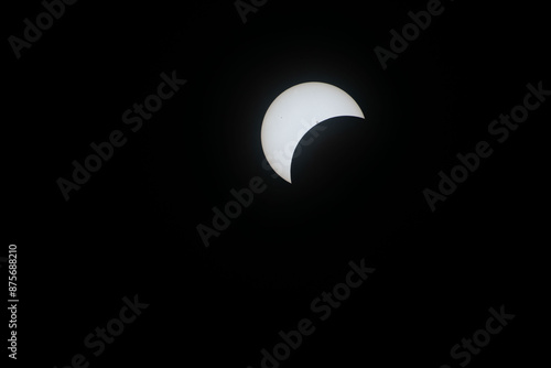 Total eclipse waxing as moon begins to cover the sun