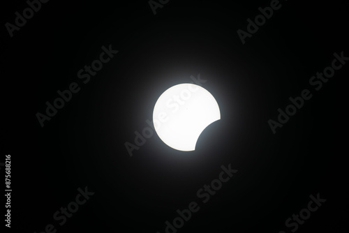 Total eclipse waxing as moon begins to cover the sun